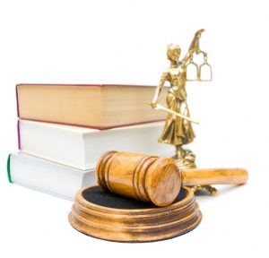 gavel, the statue of justice, and a stack of books isolated on white background. statue and the book is not in focus.